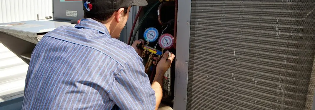HVAC technician servicing a condenser unit in Nocatee