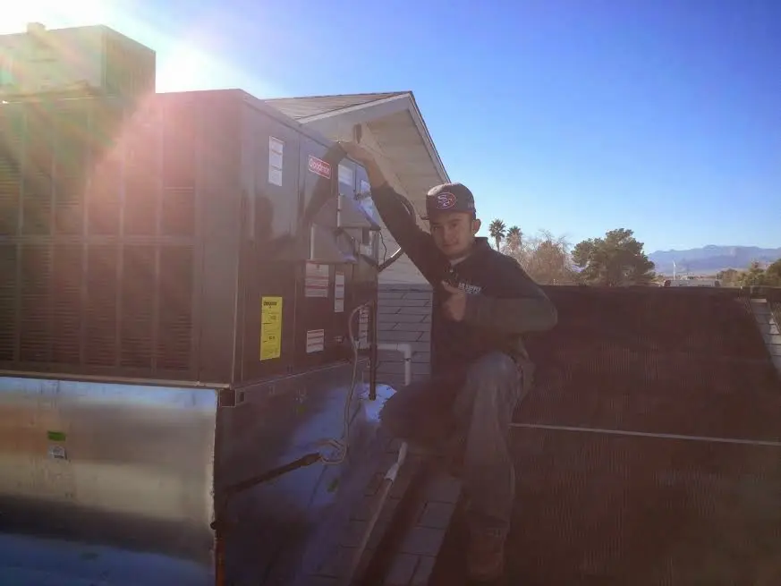 HVAC technician performing HVAC Inspection on a rooftop unit in Nocatee